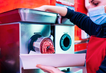 butcher woman mincing meat mincer