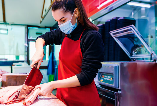 butcher woman cutting a good beef steak