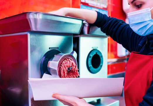 butcher woman mincing meat mincer