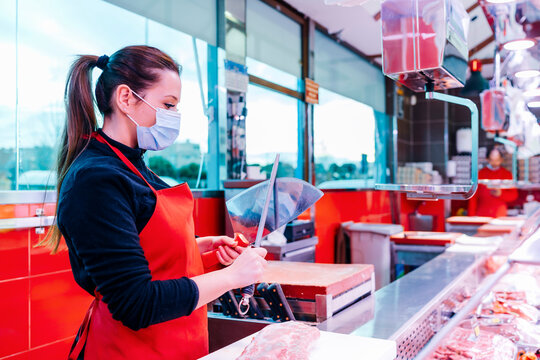 butcher woman sharpening the knife to cut meat