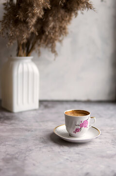 Concrete table with coffee cappuccino cup. Soft focus with noise. Minimalism photo.