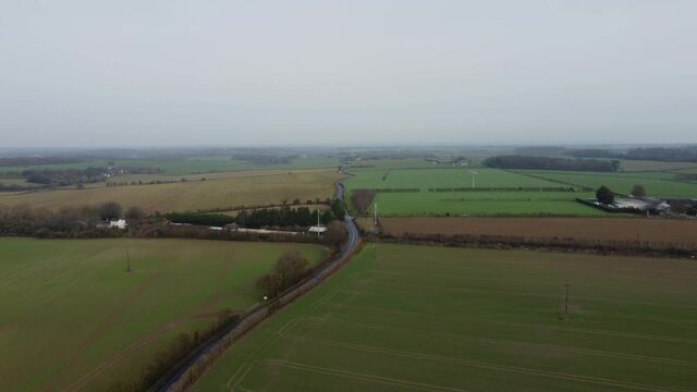 Drone footage of a crossroads in the Kent countryside. Scenery with a road.