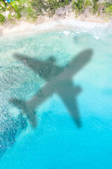 Fototapeta na wymiar Travel traveling vacation sea symbolic picture airplane flying Seychelles portrait format beach water
