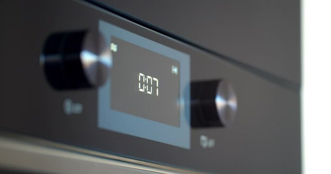 Close up of modern built-in oven with coking timer on display