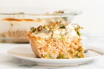 Broccoli rice casserole served for one on a white plate