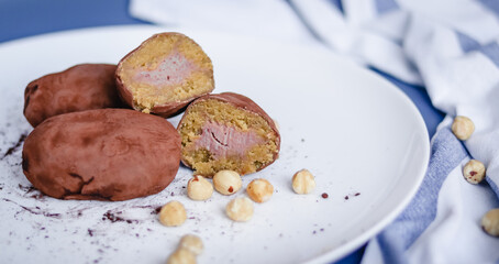 Filled cutaway potato cake on a plate with hazelnuts