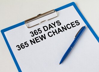 Obraz premium Clipboard with text 365 Days 365 New Chances and blue pen