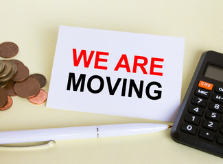 Visit card with text Financial We Are Moving with white pen and coins
