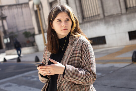 girl with a smartphone in her hands on a street in Buenos Aires