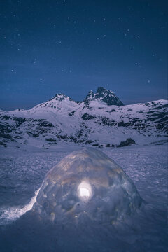 Igloo under starry sky against Midi d'Ossau during winter, Laruns, Fr