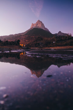 Scenic mountain reflected on a lake during dusk in the Pyrenees, Spain