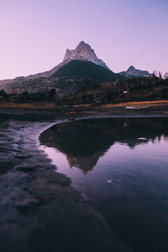 Scenic mountain reflected on a lake during dusk in the Pyrenees, Spain