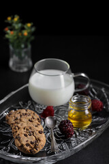 Chocolate Chip Cookies and milk on dark