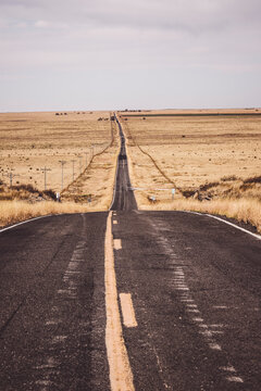 Isolated, lonely road through grassland in northern New Mexico