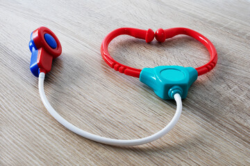 Children's stethoscope in the form of a heart on the table