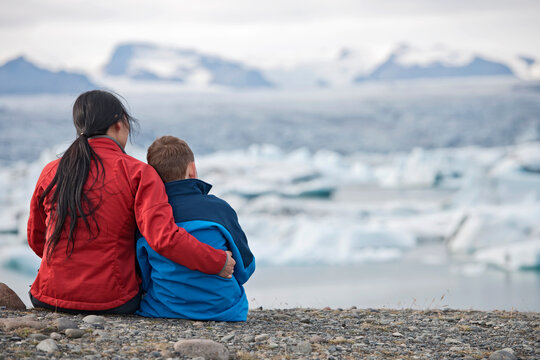 Mother and son looking at glacier lagoon in Iceland