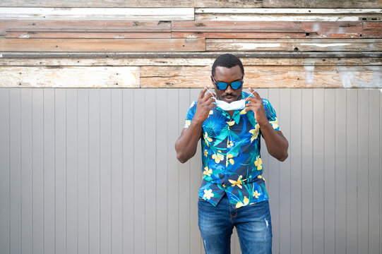 A young black man with a mask in the covid-19 pandemic season.