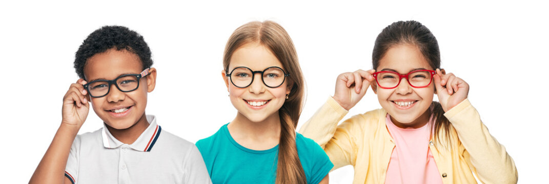 Group of smiling multiethnic kids wearing modern eyeglasses on white background. Children's vision corrective concept
