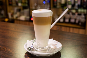 coffee latte in glass cup on wooden table in bar