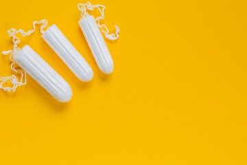 .Feminine hygienic tampons made of natural cotton on a bright background. Menstrual period concept. Means of protection for women.