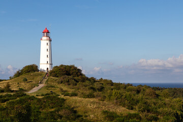 Fototapeta na wymiar Hiddensee lighthouse on the coast of island country