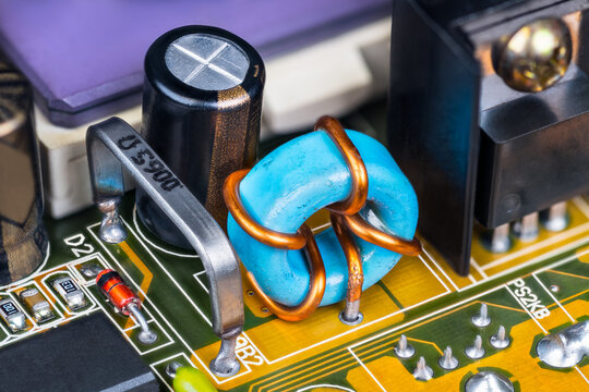 Electronic Components On Printed Circuit Board Inside Of Computer Hardware. Low Ohmic Open Air Resistor, Toroidal Inductor And Capacitor On PCB With Detail Of Ceramic Microprocessor. Electrotechnics.