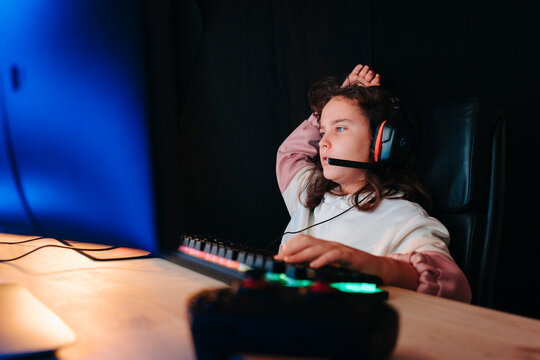 Study Room Of An Angry Kid Gamer With Chair For Personal Computer, Keyboard For Flow In Neon Color Blur Background.