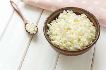 Cottage cheese with apples for breakfast in a bowl close up. pink polka dot napkin. Top view image. Copyspace for your text