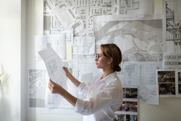 Smart architect examining draft during work