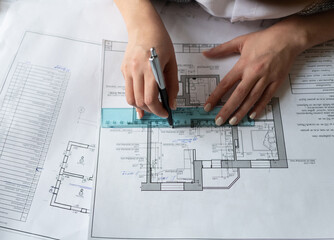 Cropped architect drawing line on draft