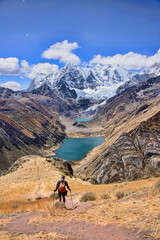 A trekker descending down to Laguna Jahuacocha and the entire Cordillera Huayhuash, Ancash, Peru.