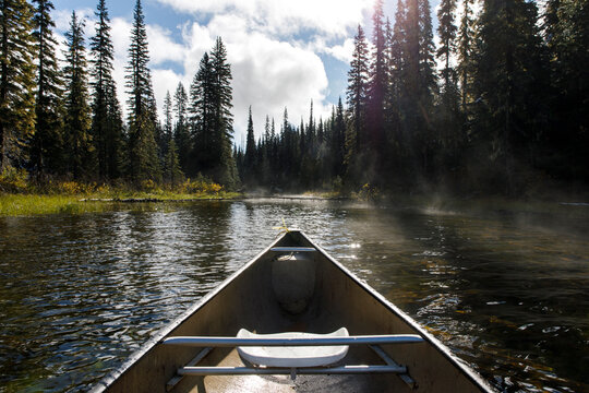Bow of canoe on sunny day on a misty lake in British Columbia, Canada