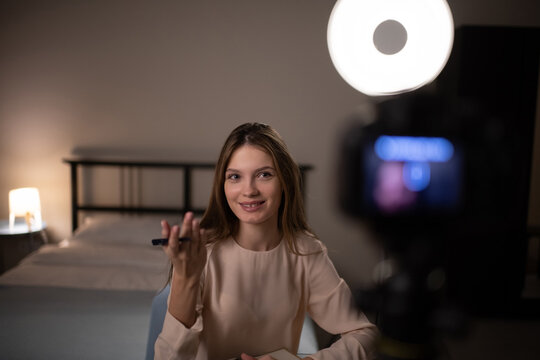 Cheerful young blogger talking to camera