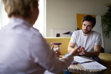 Counselor explaining psychotherapy test results to serious client
