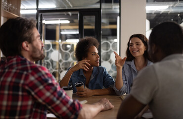 Happy lady speaking with multiethnic colleagues