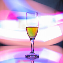 glass glass with champagne on a multicolored background