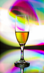 glass glass with champagne on a multicolored background