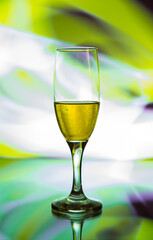 glass glass with champagne on a multicolored background