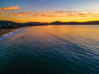 Summer aerial sunrise seascape with high cloud