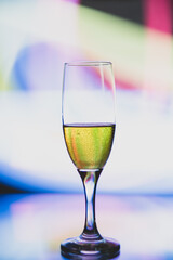 glass glass with champagne on a multicolored background