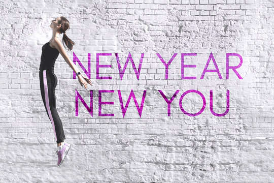 New year new you - inspirational motivational quote in the form of graffiti on the background of an old white brick wall. High quality photo