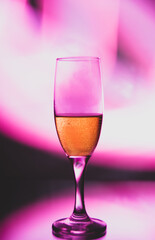 glass glass with champagne on a multicolored background