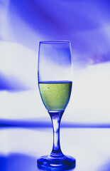 glass glass with champagne on a multicolored background