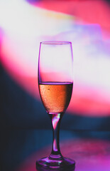 glass glass with champagne on a multicolored background