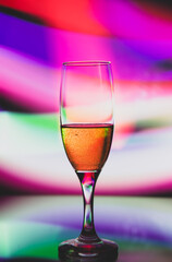 glass glass with champagne on a multicolored background