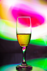 glass glass with champagne on a multicolored background