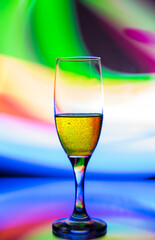 glass glass with champagne on a multicolored background