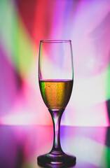 glass glass with champagne on a multicolored background