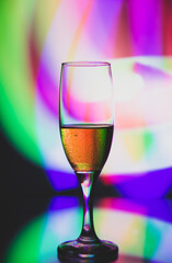 glass glass with champagne on a multicolored background