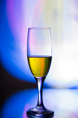 glass glass with champagne on a multicolored background
